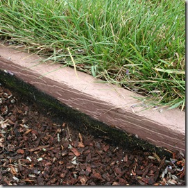 landscape fabric folded up along edging